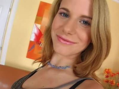 Ein blondes Babe masturbiert auf einer Couch